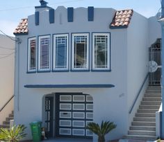 a white house with blue trim and windows