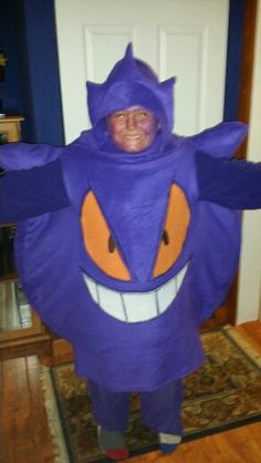 a person in a purple costume standing on a rug