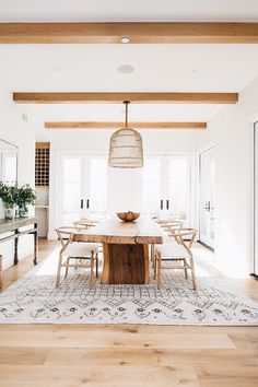 an image of a dining room setting with wood table and chairs