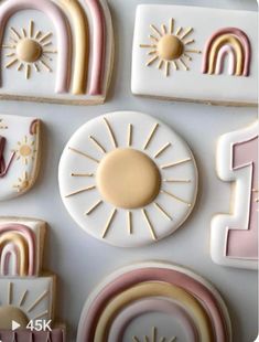 the cookies are decorated with rainbows and sunbursts in pastel colors