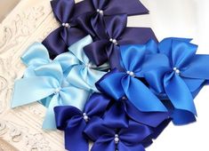 blue satin ribbon bows with pearls, high quality handmade light pale baby blue bows, royal blue bows, bright dark blue, navy blue bowsColor: 5 blue shadesBow size: approx. 7x7cm (3x3in)Ribbon width: 2,5cm (1in)Min quantity: 10piecesHOW TO ORDER******************1)Choose the color (choose the color you need from the drop down menu)2)Select the amount you need (if you cannot choose the amount you need from the drop down menu, message me for a custom amount)3)Wait for your package to arriveSHIPPING Elegant Blue Ribbon Bow, Blue Ribbon Bow For Party, Blue Party Bow With Ribbon, Blue Bow Tie With Ribbon As A Gift, Rustic Crafts, Satin Ribbon Bow, Tiny Bow, Gift Wrapping Bows, Wedding Tags