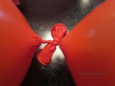 an orange balloon with a bow tied around it