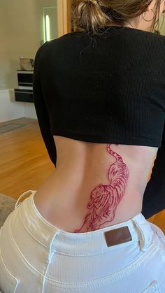 a woman with a bird tattoo on her back