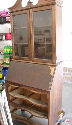 an old fashioned wooden desk with glass doors