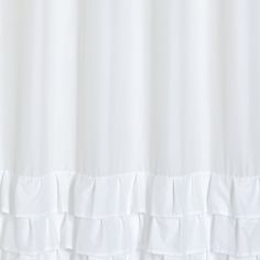 a white shower curtain with ruffled edges