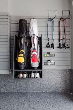 there are several pairs of shoes and backpacks on the shelf next to each other