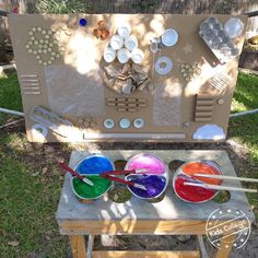 an outdoor art project with paints and spoons