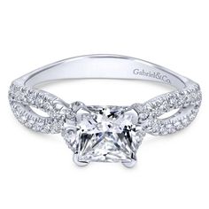 a white gold engagement ring with diamonds on the band and a round brilliant center stone