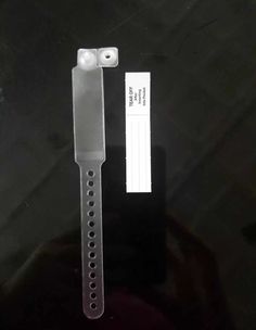 the watch strap is attached to the back of the watch case, and it has a white rubber band