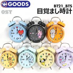 five clocks with cartoon characters on them in different colors and sizes, all showing the time