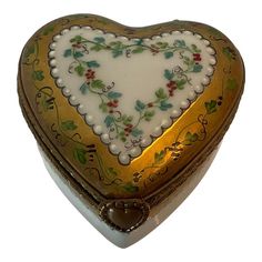 a decorative heart shaped box with gold trimming