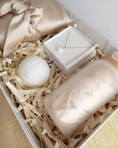 an open box with some items in it on top of a wooden floor next to a white ball