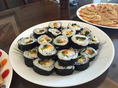 sushi and crackers are on the table ready to be served at a restaurant