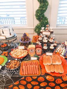 a table topped with lots of food and desserts