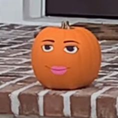 an orange pumpkin with a face drawn on it