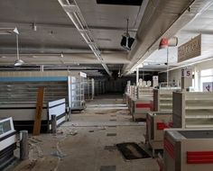 an empty office with lots of desks and filing cabinets in the middle of it