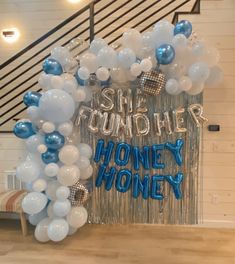 a bunch of balloons that are in the shape of a honey money sign on a wall