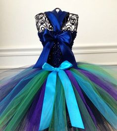 a blue and green tutule dress with a large bow on the top,