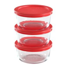 three glass containers with red lids are stacked on top of each other in front of a white background