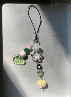 a necklace with beads and charms hanging from it