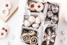 a box filled with lots of different types of pastries on top of a table