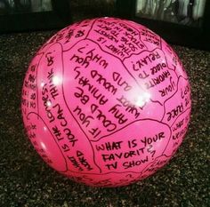 a large pink ball with writing on it