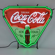 a neon sign that says drink coca - cola on the front and side of it