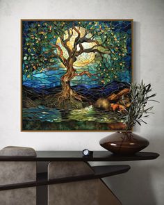 a painting hanging on the wall next to a vase with an olive tree in it