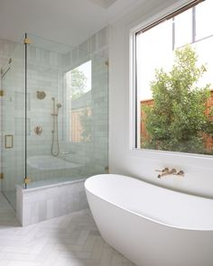 a white bath tub sitting next to a window