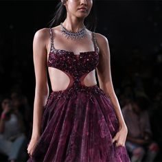 Maroon and black printed organza gown with crystal embroidery across bodice and black feathers sprinkled allover. Embellished Organza Evening Dress For Party, Party Organza Evening Dress Embellished, Embellished Organza Ball Gown Evening Dress, Glamorous Organza Evening Gown, Glamorous Organza Gown With Sweetheart Neckline, Glamorous Organza Gown For Evening, Glamorous Organza Gown For Prom, Glamorous Organza Gown For Party, Luxury Hand Embellished Party Gown