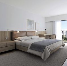 a bedroom with a bed, dressers and large window overlooking the cityscape