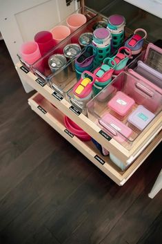 the drawers are filled with various items and containers for making dishes, cups, and utensils