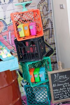 three baskets are stacked on top of each other in front of a chalkboard sign