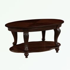 an oval wooden coffee table with carved legs