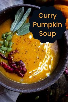 a bowl filled with curry pumpkin soup on top of a table