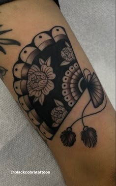 a black and white tattoo design on the arm