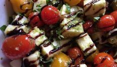 a white plate topped with salad and meat