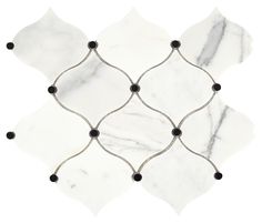 a white marble tile with black dots on the edges and an intricate design in the middle