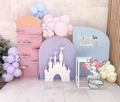 a little mermaid themed birthday party with balloons and decorations on the walls, along with princess castle backdrops