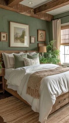 a bedroom with green walls and white bedding in the center, along with two windows