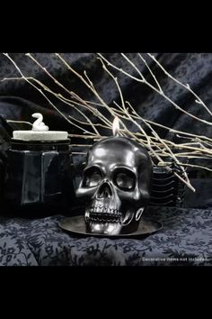 a candle that is sitting next to a skull