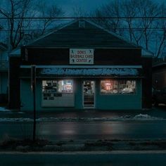 an empty store front at night with the lights on