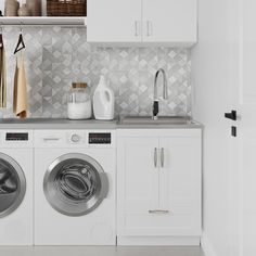 a washer and dryer in a white laundry room with tile backsplash