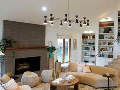 a living room filled with furniture and a fire place in the middle of a room