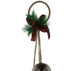 a bell with a red and green bow hanging from it's side