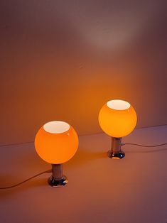 two lamps sitting next to each other on a table