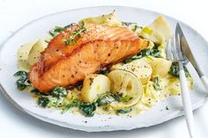 a white plate topped with salmon and potatoes