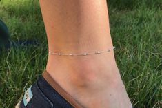 This Sterling Silver Anklet features tiny diamond cut rounds spaced between 3mm ball beads. Diamond cut means the silver beads are cut in a specific way to capture the light and reflect it back to our eyes making this anklet super shiny! You can layer this anklet or wear it on its own! This Anklet is adjustable and fits 9 - 10 Inches **To Add a charm, please message me for options and pricing** **For group orders, please message me for pricing** This item is elegantly wrapped and shipped ready for gifting **To add a personal message with your order if giving as a gift, please leave a comment at checkout or contact me directly** Please note, for international orders outside of Canada and the USA, a local customs tax may apply in your country or region. KyperCo is not responsible for customs Summer Silver Bracelets With Tiny Beads, Silver Jewelry With Round Beads For Summer, Hypoallergenic Silver Bracelets For Summer, Dainty Sterling Silver Anklets For Summer, Silver Anklets With Tiny Beads For Summer, Silver Party Anklets Ankle Wrap, Silver Beaded Anklets For Gift, One Leg Anklet Silver, Adjustable Silver Ankle Wrap Anklet