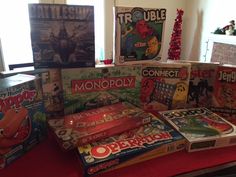 many games are on the table in front of a window with christmas decorations around it