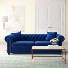 a living room with a blue couch and coffee table